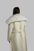 Back view of a long white cream winter coat