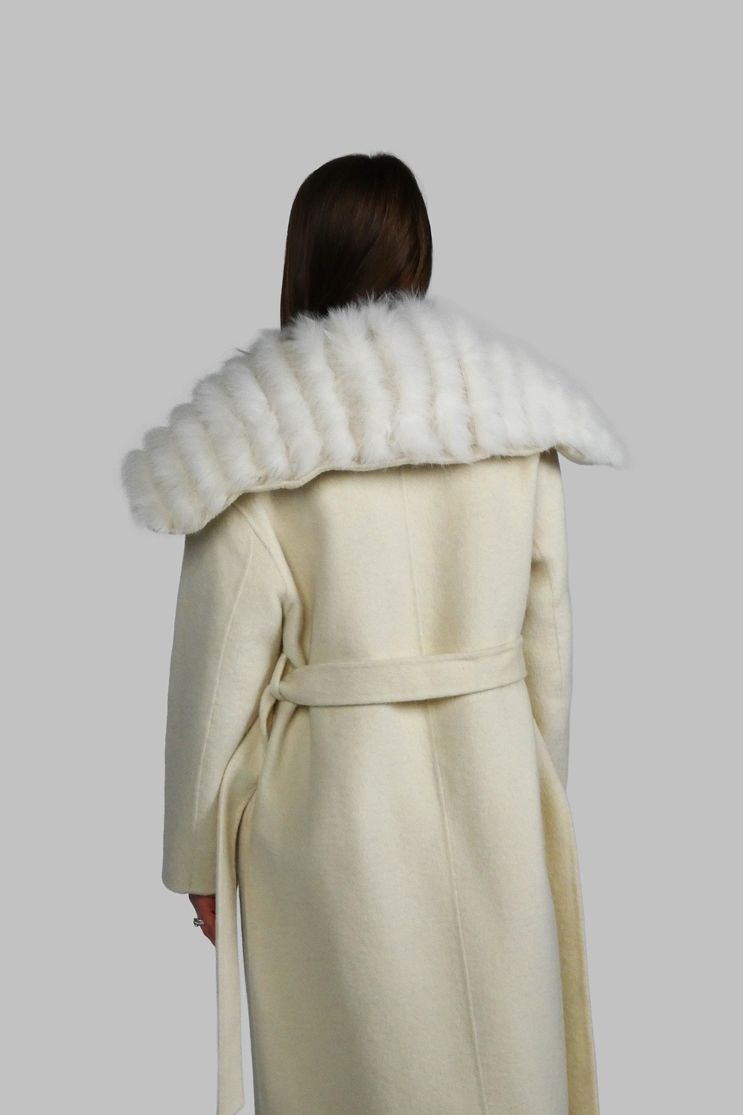 Back view of a long white cream winter coat