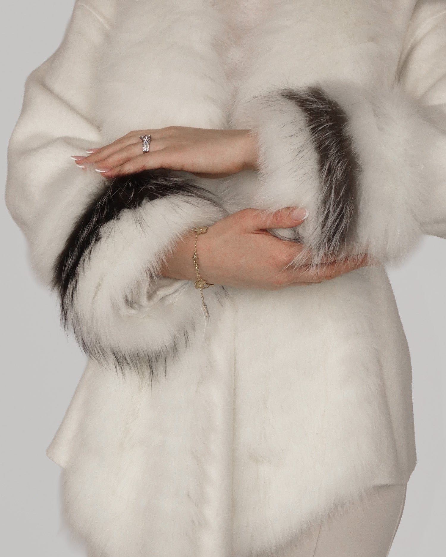 Close-up of torso showing a white fur coat with dark grey trim
