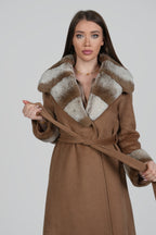 Woman wearing a white coat with brown fur collar, facing forward