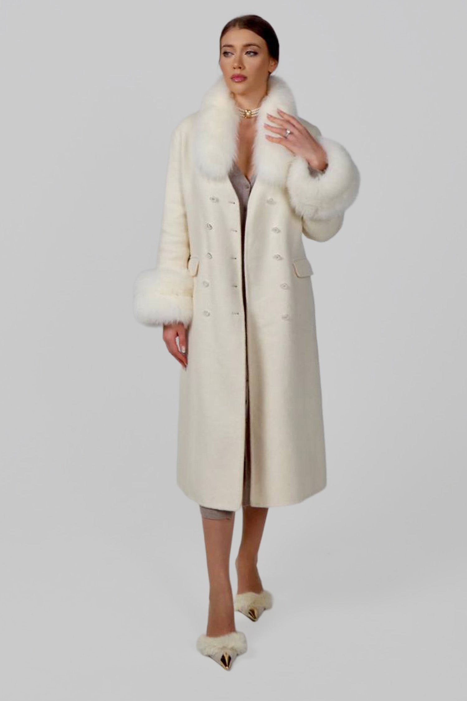 Woman wearing a beige wrap coat, shown in a walking pose